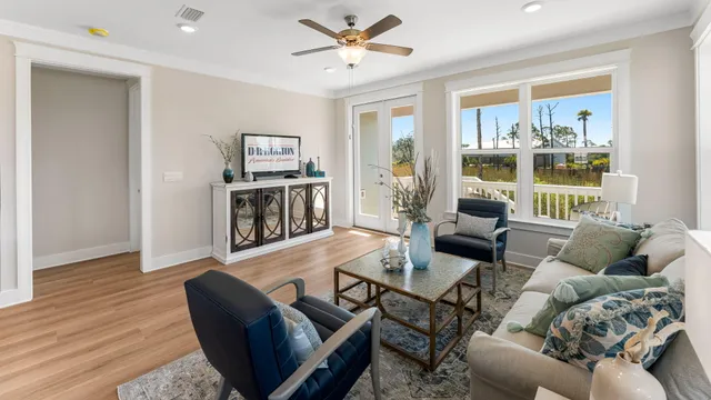 a living room with furniture and large window