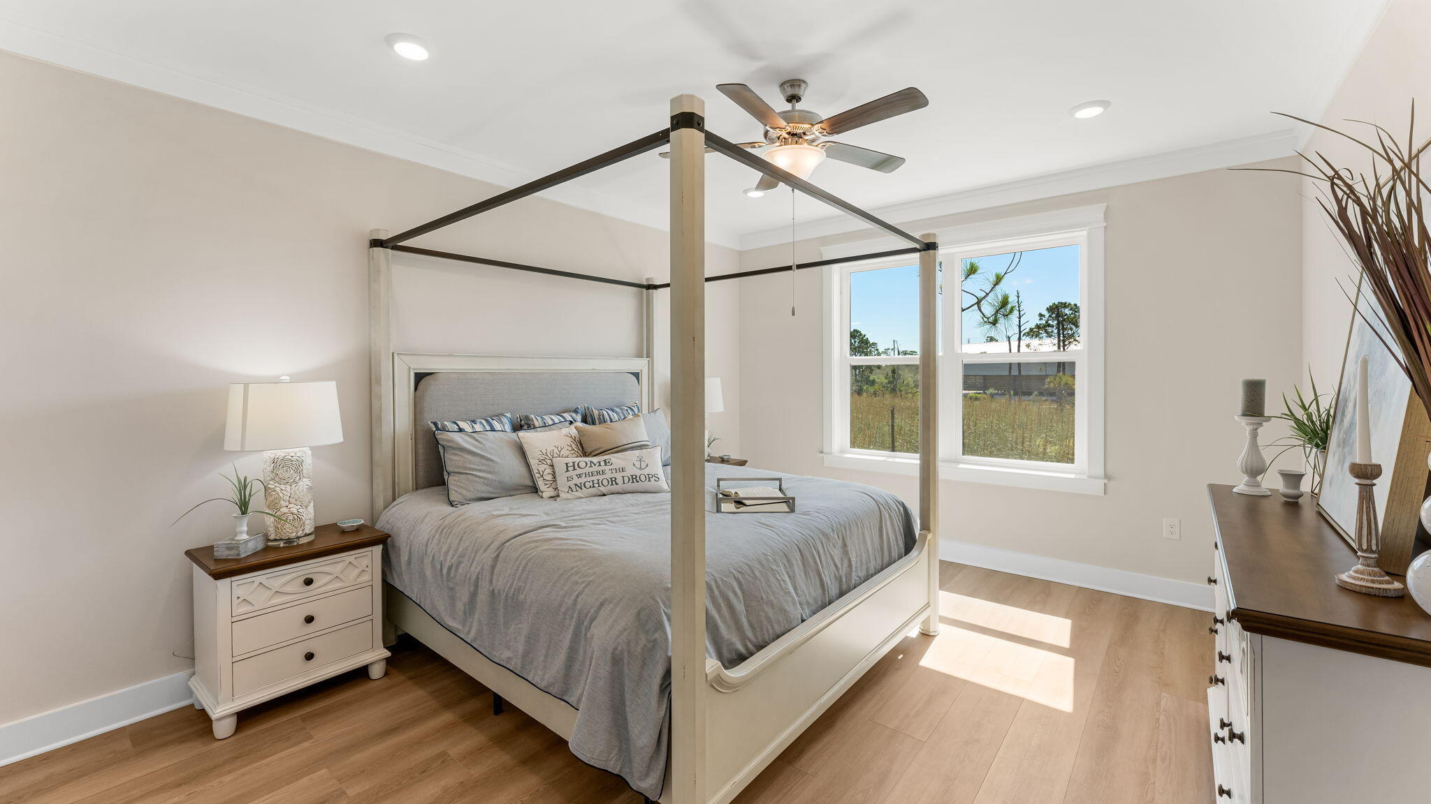 112 Marsh View Ridge Ln Cape Port St. Joe, FL 32456 - Photo 14 of 32 a bedroom with a large bed and a flat tv screen on dresser