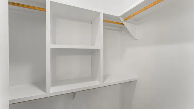 a bathroom with double vanity sink a mirror and a shower