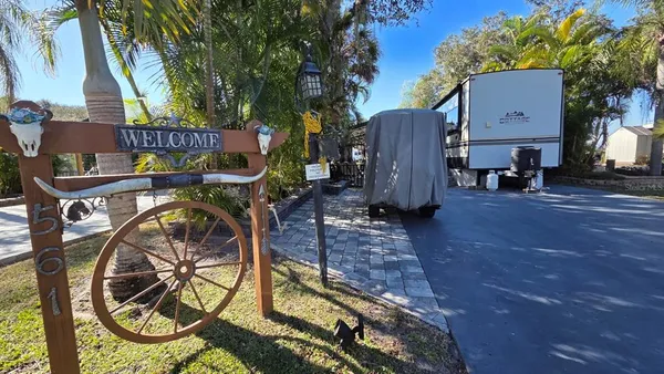 a view of a chairs and table in the backyard