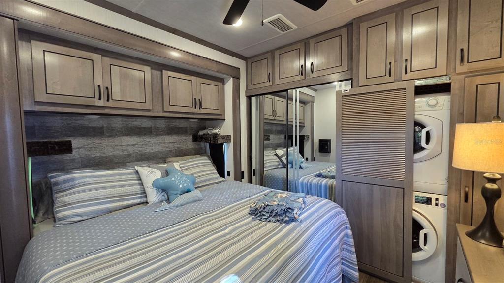 561 Waterway Drive River Ranch, FL 33867 - Photo 13 of 18 a bedroom with a bed next to a ceiling fan