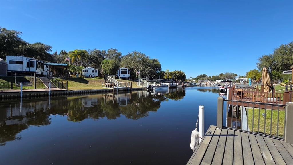 561 Waterway Drive River Ranch, FL 33867 - Photo 2 of 18 a view of a lake with boats and palm trees