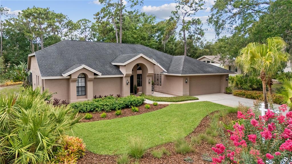 3372 Brian Road South Palm Harbor, FL 34685 - Photo 37 of 45 a front view of a house with a yard and garage