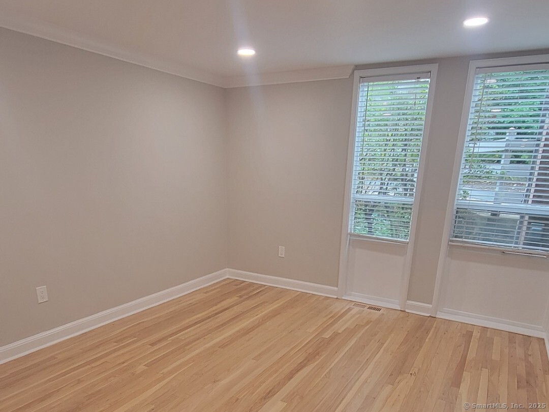 160 Fairfield Woods Road, Unit 43 Fairfield, CT 06825 - Photo 18 of 25 wooden floor in an empty room with a window