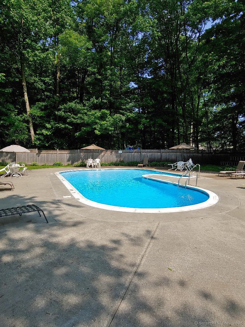 160 Fairfield Woods Road, Unit 43 Fairfield, CT 06825 - Photo 23 of 25 a view of a swimming pool with a yard