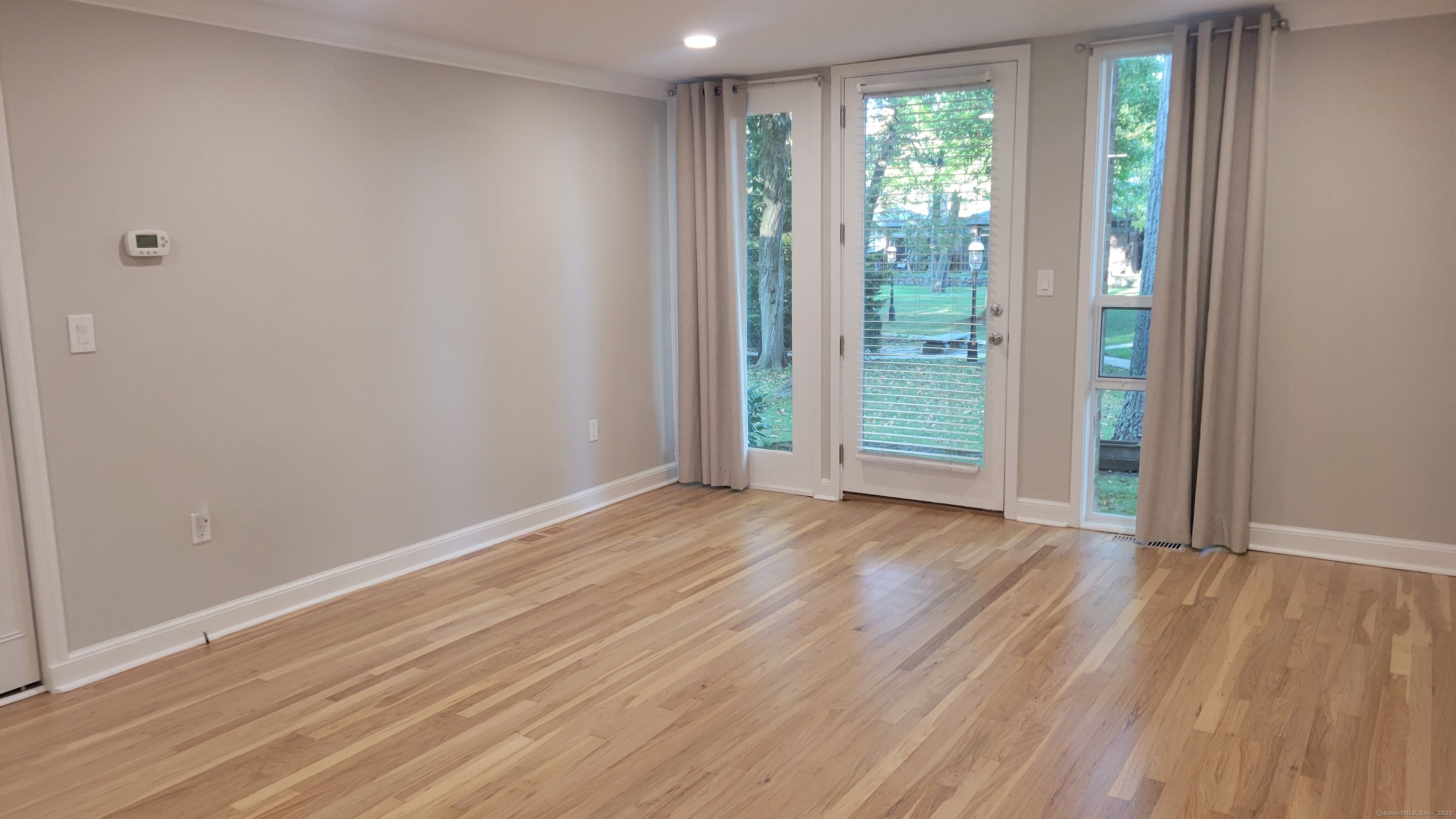 160 Fairfield Woods Road, Unit 43 Fairfield, CT 06825 - Photo 3 of 25 a view of a room with wooden floor and window