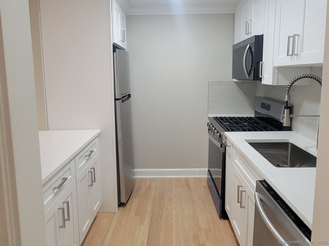 160 Fairfield Woods Road, Unit 43 Fairfield, CT 06825 - Photo 8 of 25 a kitchen with a sink stove and refrigerator