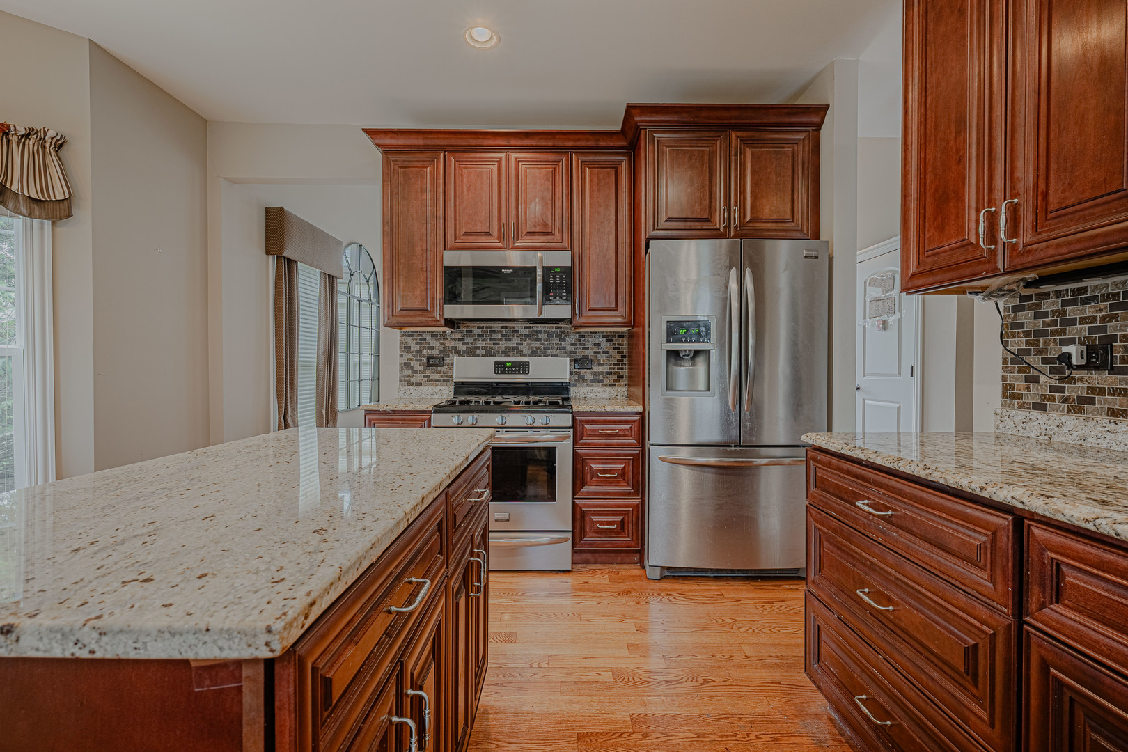 171 Partridge Lane Bartlett, IL 60103 - Photo 9 of 34 a kitchen with kitchen island granite countertop stainless steel appliances and wooden cabinets