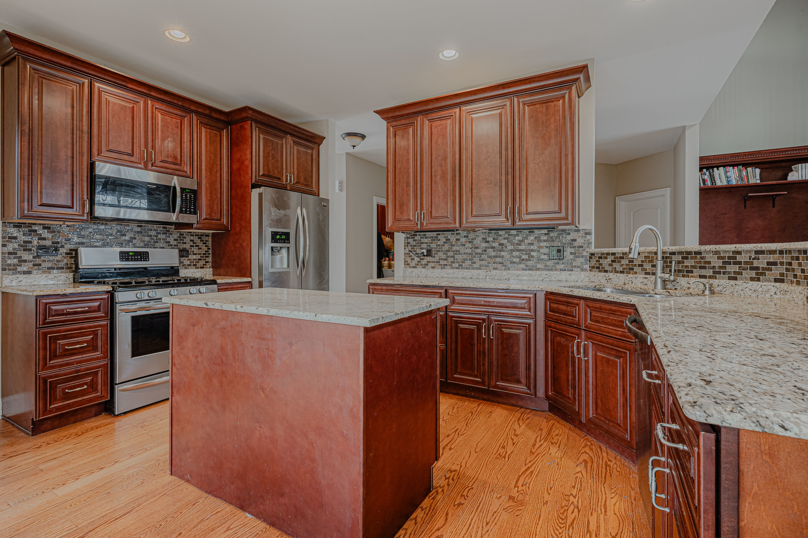 171 Partridge Lane Bartlett, IL 60103 - Photo 10 of 34 a kitchen with stainless steel appliances granite countertop a stove top oven a sink and dishwasher a oven with wooden cabinets