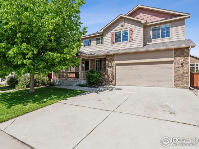 a small white house with a yard and garage