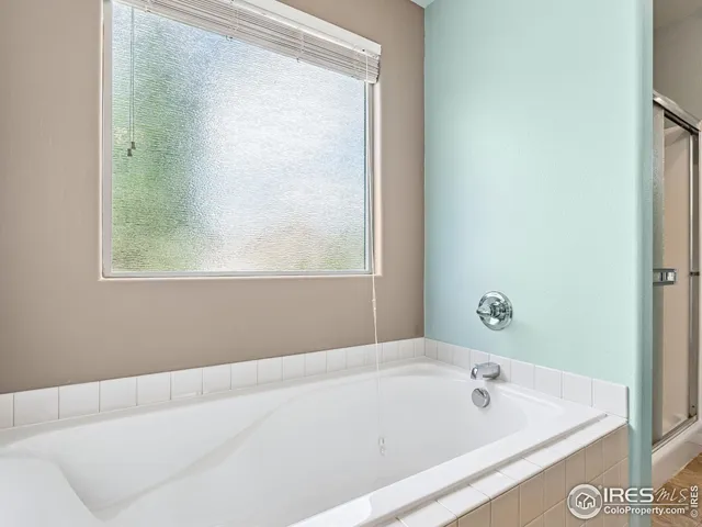 a bathroom with a bathtub and a window