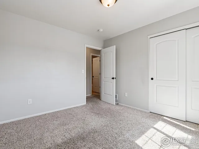 a view of an empty room and a window