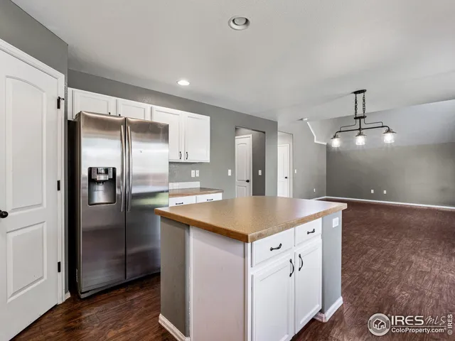 a kitchen with a refrigerator and countertop