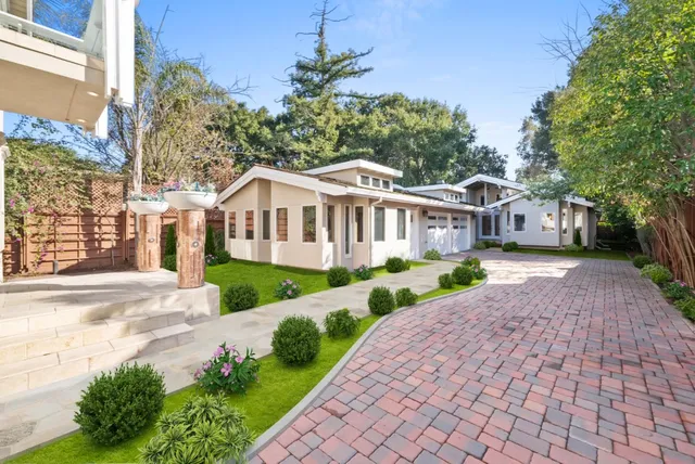 a front view of a house with a garden and outdoor seating