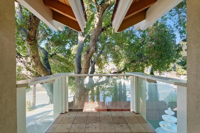 a view of a glass door and the trees