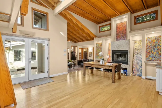 a view of a patio with dining table and chairs with wooden floor