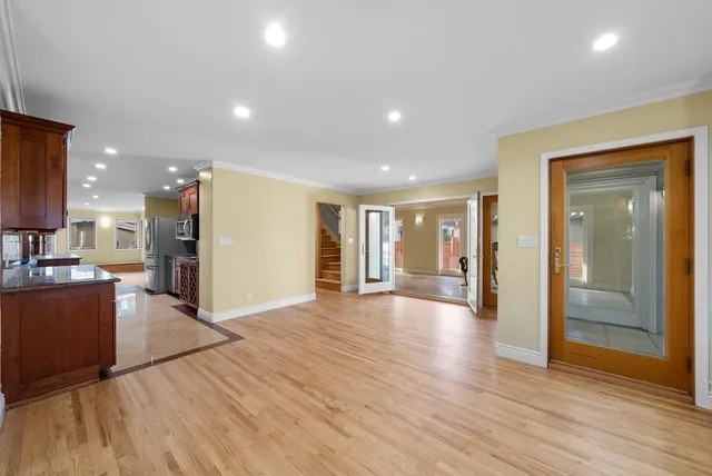 a view of a big room with wooden floor and windows