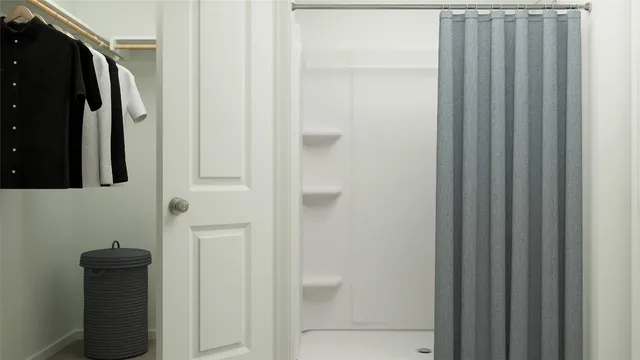 a bathroom with a shower and a mirror