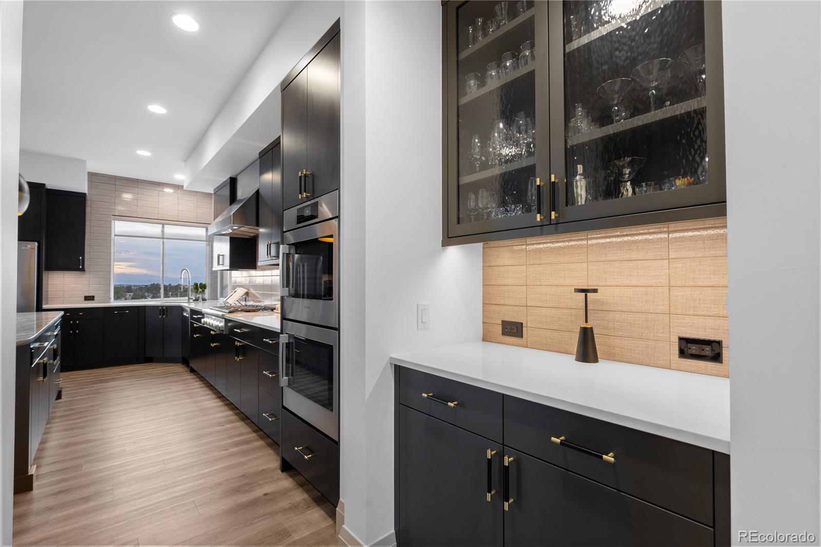 10689 Shadow Pines Road Parker, CO 80138 - Photo 17 of 50 a kitchen with stainless steel appliances granite countertop a refrigerator a sink a stove and wooden floor
