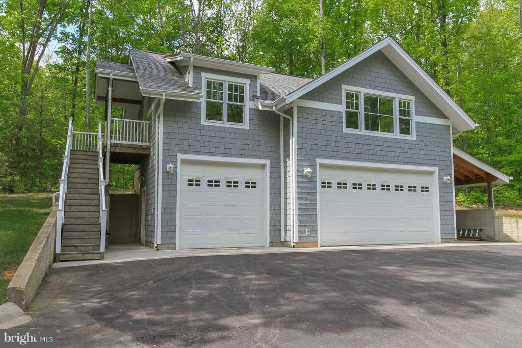 3749 Breaknock Road Bumpass, VA 23024 - Photo 2 of 29 3 car garage,28'deep9.5' tall, bunkhouse over top