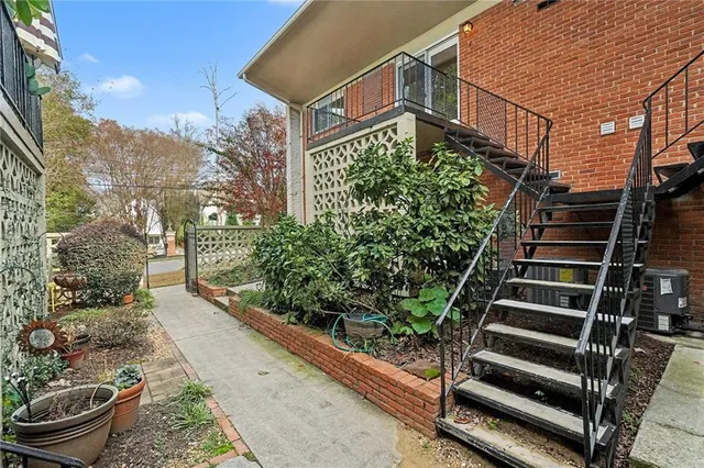 a view of a garden with an outdoor seating
