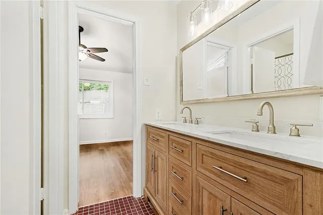 a spacious bathroom with a sink a mirror and a shower