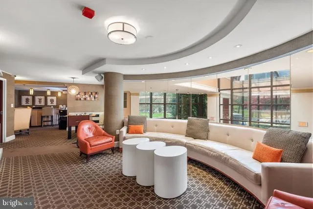 a living room with furniture and a chandelier