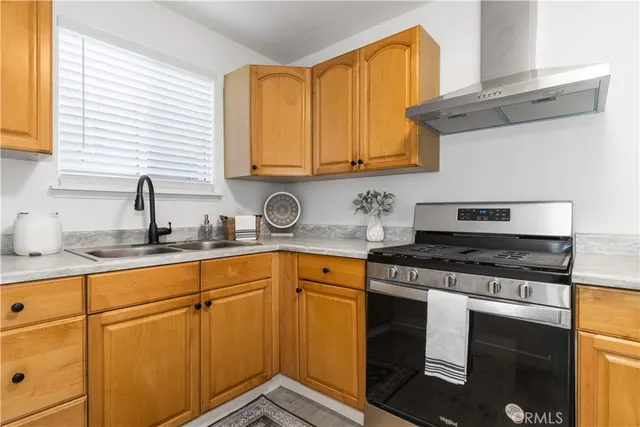 a kitchen with granite countertop cabinets stainless steel appliances and a sink