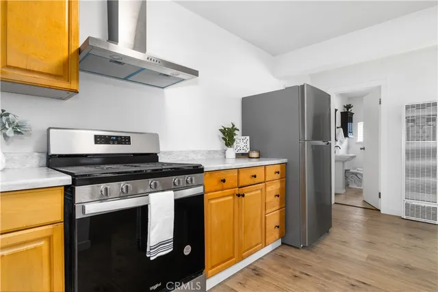 a kitchen with stainless steel appliances granite countertop a refrigerator stove and sink