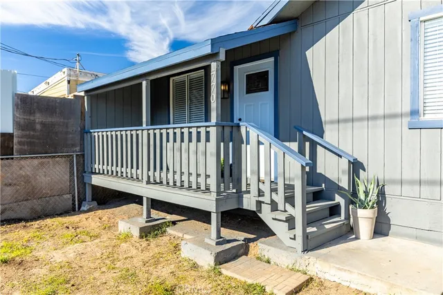 a view of a house with a wooden fence