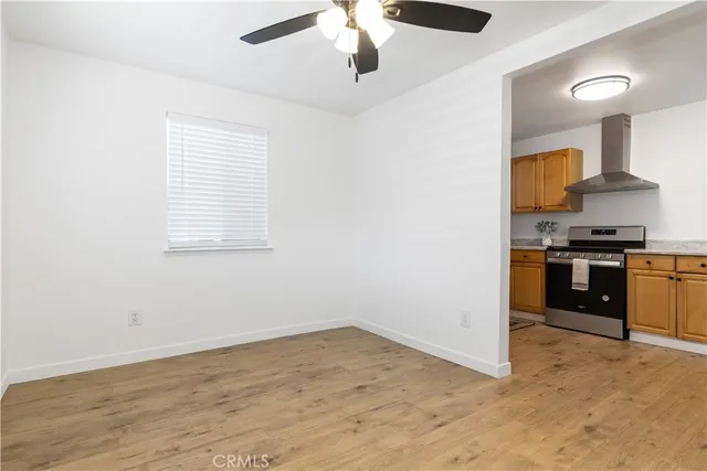 a view of kitchen with stove microwave and cabinets