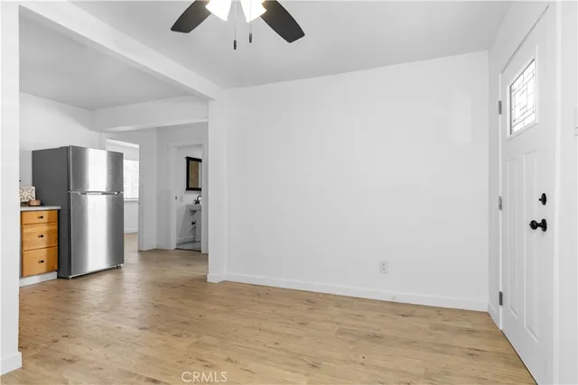 a view of a kitchen with a refrigerator a ceiling fan and a dishwasher