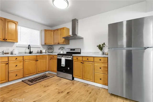 a kitchen with stainless steel appliances granite countertop a refrigerator sink and cabinets