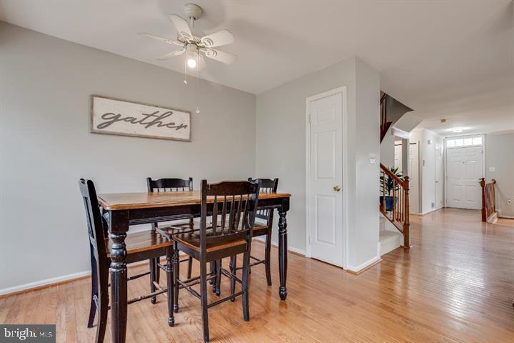 21186 Winding Brook Square Ashburn, VA 20147 - Photo 11 of 42 a view of a dining room with furniture and wooden floor