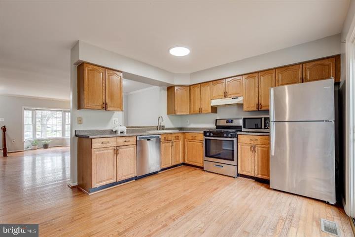 21186 Winding Brook Square Ashburn, VA 20147 - Photo 14 of 42 a kitchen with granite countertop a refrigerator stove top oven and sink