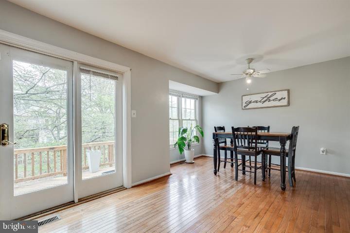21186 Winding Brook Square Ashburn, VA 20147 - Photo 15 of 42 a view of a dining room with furniture and wooden floor