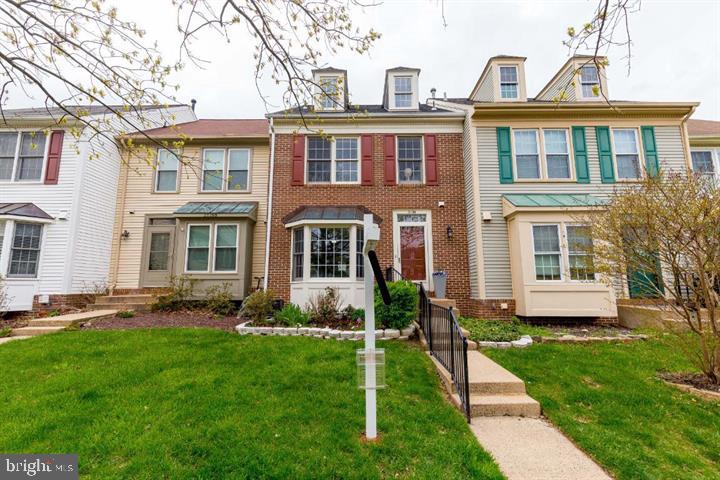 21186 Winding Brook Square Ashburn, VA 20147 - Photo 2 of 42 a front view of a house with a yard