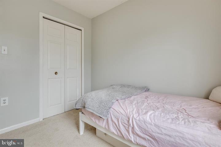 21186 Winding Brook Square Ashburn, VA 20147 - Photo 21 of 42 a bedroom with a bed and a window