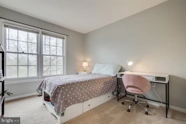 a bedroom with a bed chair and a window