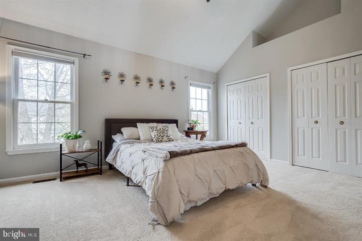 21186 Winding Brook Square Ashburn, VA 20147 - Photo 29 of 42 a spacious bedroom with a bed and a window