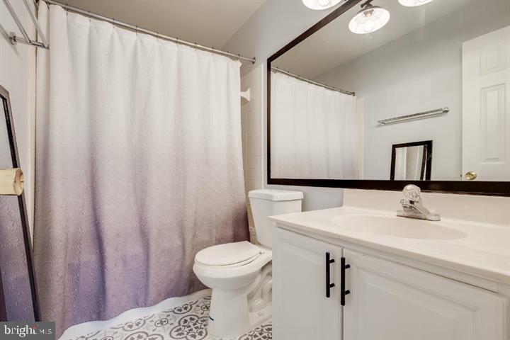 21186 Winding Brook Square Ashburn, VA 20147 - Photo 32 of 42 a bathroom with a sink a toilet and mirror