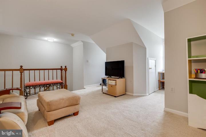21186 Winding Brook Square Ashburn, VA 20147 - Photo 34 of 42 a bedroom with furniture and a flat screen tv