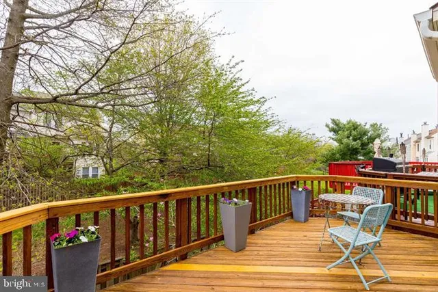 a view of balcony with wooden floor and outdoor seating