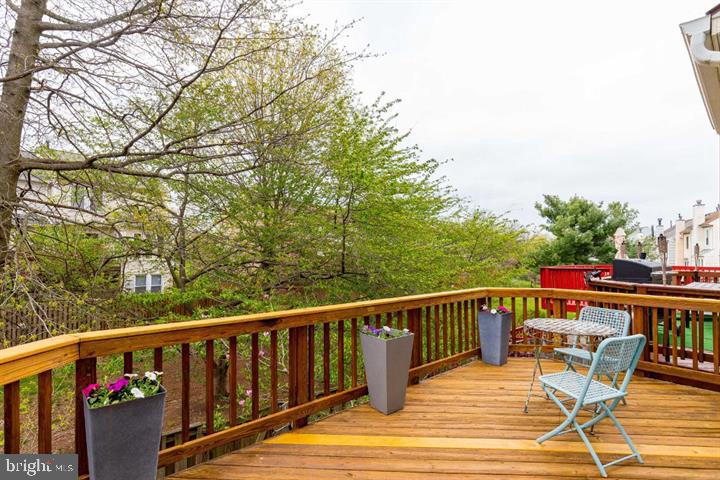 21186 Winding Brook Square Ashburn, VA 20147 - Photo 37 of 42 a view of a balcony with wooden floor and outdoor seating