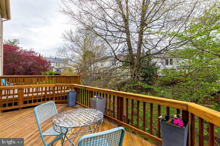 21186 Winding Brook Square Ashburn, VA 20147 - Photo 38 of 42 a view of balcony with wooden floor and outdoor seating