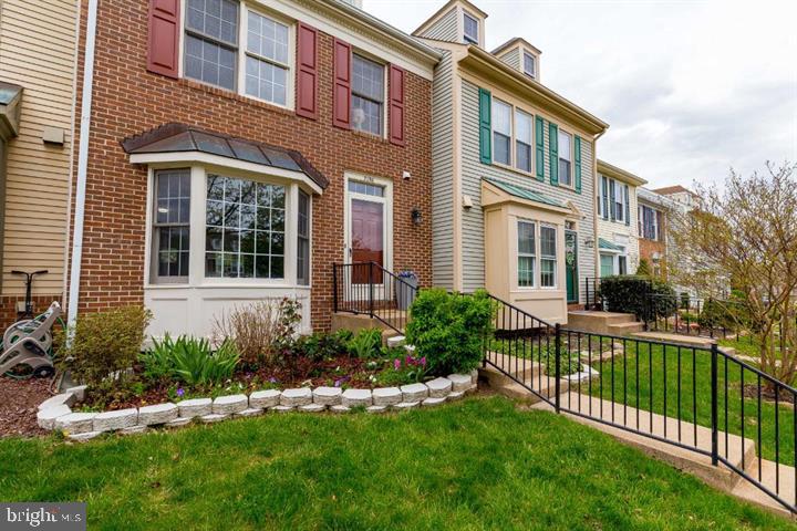 21186 Winding Brook Square Ashburn, VA 20147 - Photo 41 of 42 a front view of a house with a yard