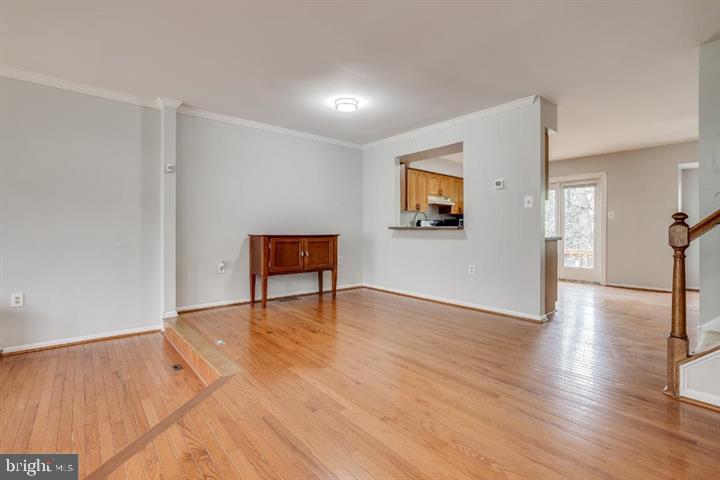 21186 Winding Brook Square Ashburn, VA 20147 - Photo 5 of 42 a view of an empty room with wooden floor