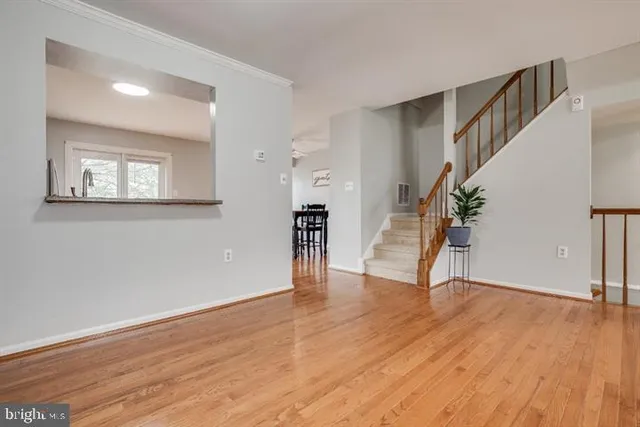 a view of an entryway with wooden floor and staircase