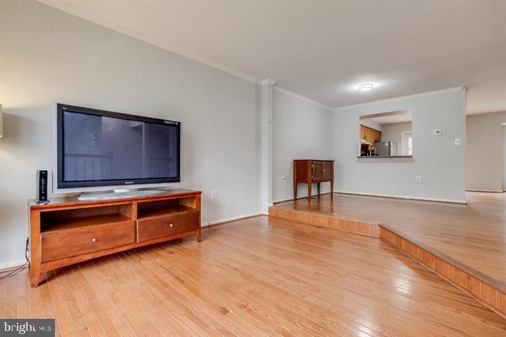 21186 Winding Brook Square Ashburn, VA 20147 - Photo 8 of 42 a room with furniture and flat screen tv