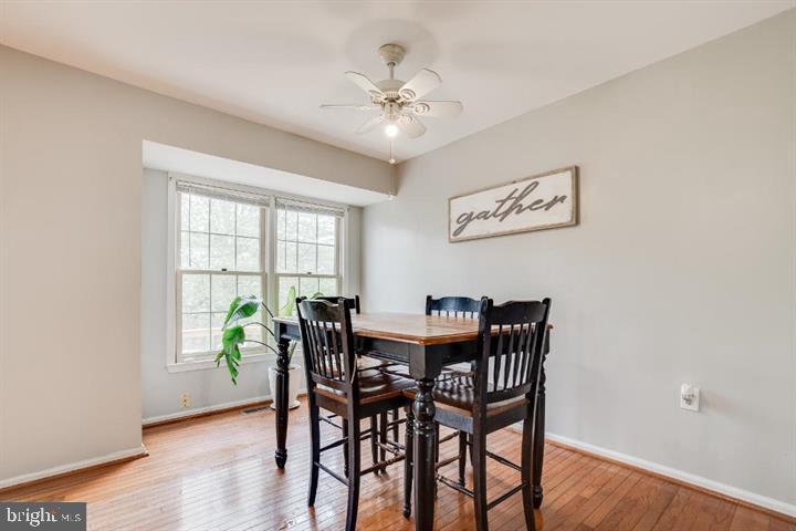 21186 Winding Brook Square Ashburn, VA 20147 - Photo 10 of 42 a view of a dining room with furniture window and wooden floor
